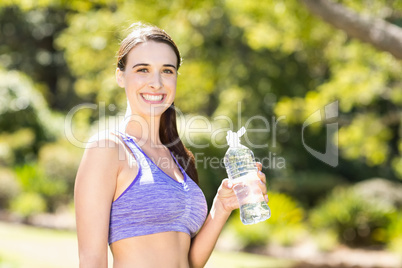 Portrait of woman holding water bottle