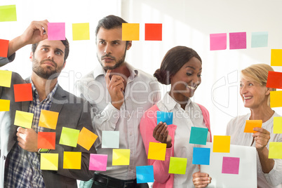 Business people looking at adhesive notes