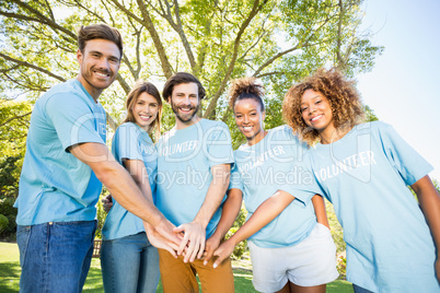Portrait of volunteer group forming hands stack