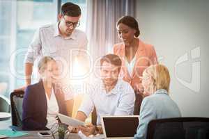 Group of business people interacting using digital tablet