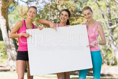 Group of volunteer holding a blank sheet and pointing to it