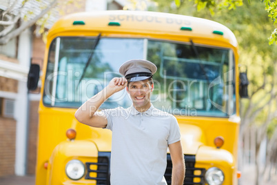 Bus driver smiling in front of bus