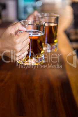 Hands holding beer