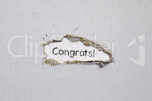 The word congrats appearing behind torn paper.