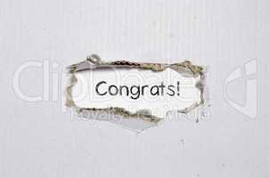 The word congrats appearing behind torn paper.