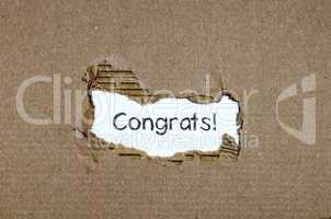 The word congrats appearing behind torn paper.