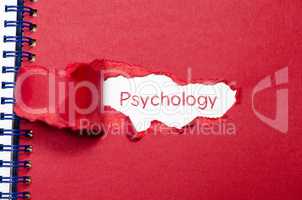 The word psychology appearing behind torn paper.