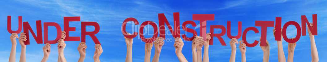 Many People Hands Holding Red Word Under Construction Blue Sky