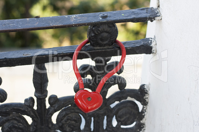 Red Locks in heart shape on wedding bridge photo.  Love concept.