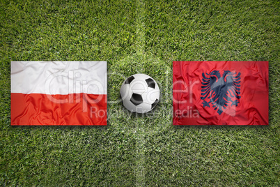 Poland vs. Albania flags on soccer field