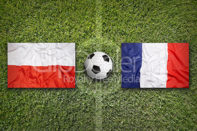 Poland vs. France flags on soccer field