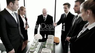 Architects and investors with model of houses