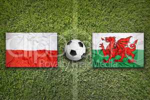 Poland vs. Wales flags on soccer field