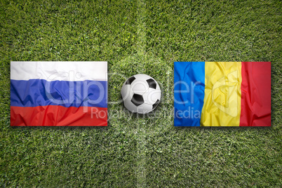 Russia vs. Romania flags on soccer field