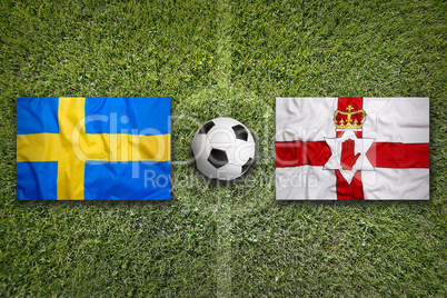 Sweden vs. Northern Ireland flags on soccer field
