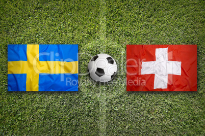 Sweden vs. Switzerland flags on soccer field