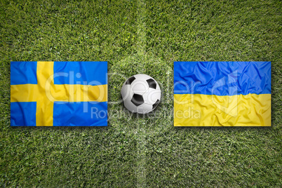 Sweden vs. Ukraine flags on soccer field