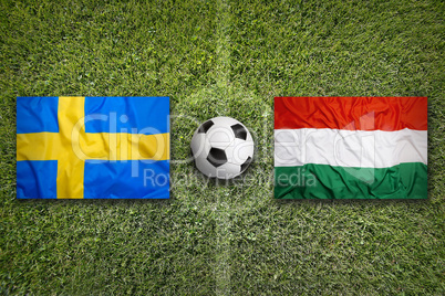 Sweden vs. Hungary flags on soccer field