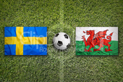 Sweden vs. Wales flags on soccer field