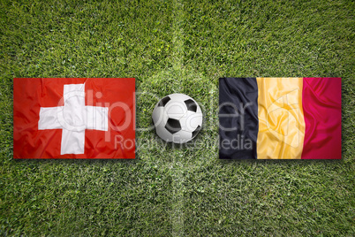 Switzerland vs. Belgium flags on soccer field