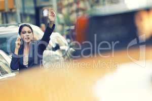 New York City Woman on Cell Phone Hailing a Yellow Taxi Cab