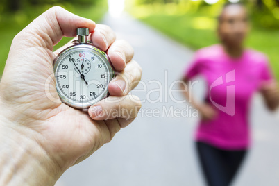 Stopwatch Timer and Young Woman Running