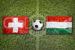 Switzerland vs. Hungary flags on soccer field
