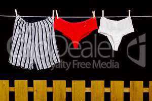 Woman panties and man underwear on clothesline