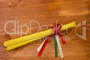 Pasta spaghetti tied with ribbons of the flag colors of Italy