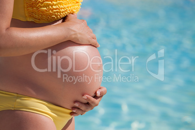 pregnant woman with hands over tummy