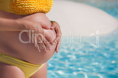 pregnant woman with hands over tummy