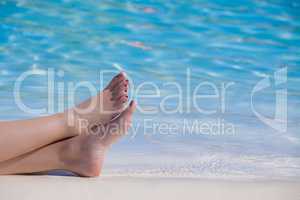 Woman feet on the pool