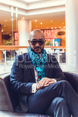 Businessman sitting on a sofa in the hotel