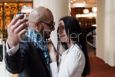 Arab businessman and girl making selfie