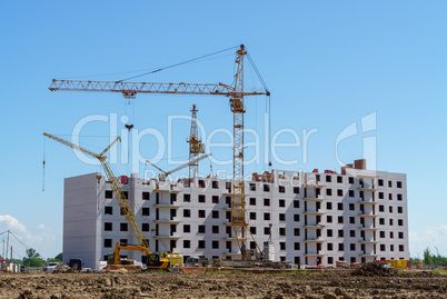Construction of a multistory building. Cranes work