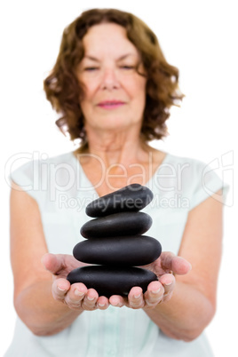 Mature woman holding pebbles
