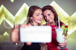 Happy women taking selfie in nightclub