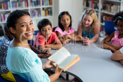 Pupils listening to their teacher reading