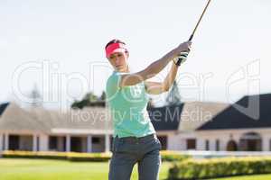 Golfer woman taking shot