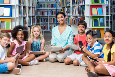 Teacher with children holding digital tablets