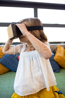 Girl looking through virtual reality in school library