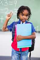 Boy gesturing while standing in classroom