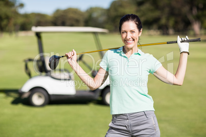 Portrait of cheerful woman carrying golf club Portrait of cheerful woman carrying golf club