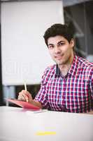Businessman writing on note pad