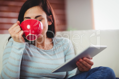 Woman drinking coffee at home