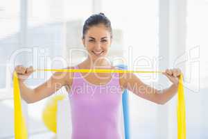 Portrait of smiling woman with resistance band