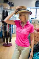 Mature woman trying on a hat