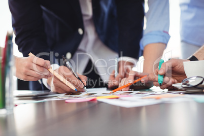 Photo editors discussing about documents on table