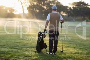 Full length Rear view of golfer