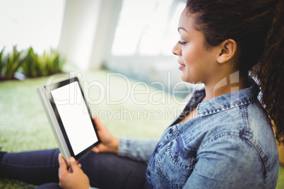 Businesswoman using digital tablet in creative office